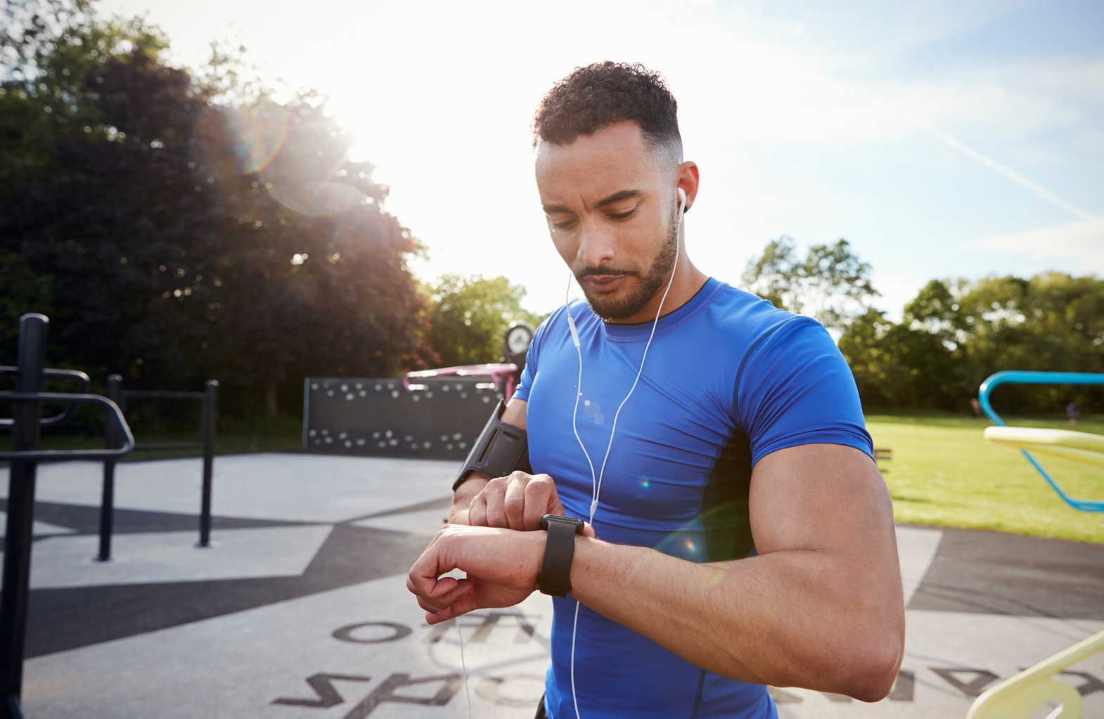 Man Setting Fitness App on Smartwatch